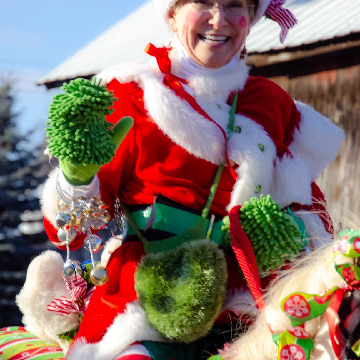 Woman in festive Santa outfit with horse.